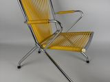 a yellow lounge chair with a metal frame and foot rest