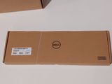 two dell laptops sitting on top of a table next to each other