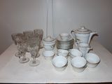 a table with a lot of dishes and cups on it