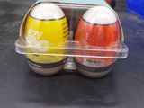 two eggs in a plastic container on a table