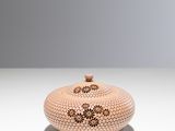 a vase that is sitting on a white table