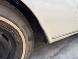 a white car that has a flat tire on it