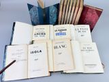 several open books sitting on top of each other on a table