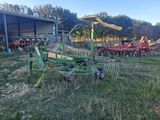 a green tractor that is parked in the grass