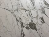 a white marble counter top with a black and white design