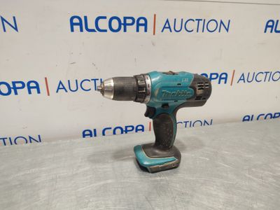 a cordless drill is shown on a table in front of a sign