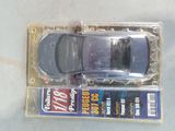 a toy car in a plastic package on a table