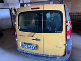 a small yellow van parked in a garage with its door open
