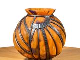 a vase that is sitting on a table with a white background