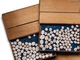 two boxes filled with white buttons on a wooden table