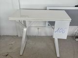 a white desk with a sign on it in a room