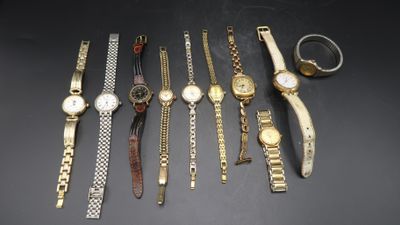 a group of watches and bracelets sitting on a table