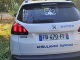 a small white car parked on the side of the road