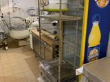 an orange juice machine in the middle of a kitchen