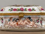 a white and gold box with a picture of two women on it
