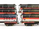two trains that are sitting side by side on a white surface