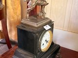 a clock sitting on a wooden table in a room