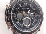 a close up of a wrist watch on a white cloth