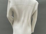 an image of a mannequin wearing a white sweater and black pants