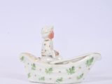 a small figurine of a man in a boat on a table