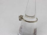 a silver ring sitting on top of a clear glass