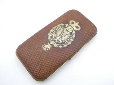 a brown case that has a gold emblem on it