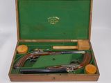 a wooden case with two guns inside of it