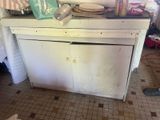 a dirty kitchen counter with a lot of clutter on it