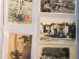 a lot of old photos in a folder on the table