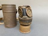 two old gas masks sitting next to each other on a table