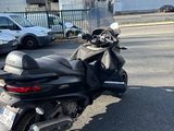 motorcycle parked on the side of the road in front of a parking lot
