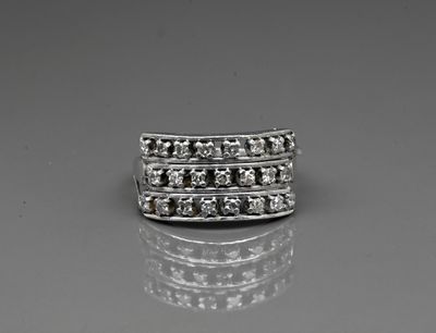 a close up of a diamond ring on a reflective surface
