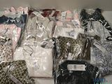 many different types of clothing in bags on a table