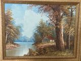 une peinture à l'huile représentant une maison au bord d'un lac, dans un cadre boisé