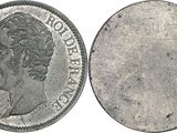 a close up of a silver coin with a woman ' s head on it