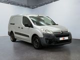 the white van is parked in a large room with white walls