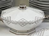 a white bowl with a lid sitting on top of a table