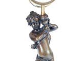 a statue of a boy holding a clock on his shoulder