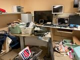 a cluttered room with a desk, computer, and other clutter
