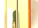 a close up of a gold metal object on a white surface