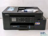 the printer is sitting on top of the desk next to a pen