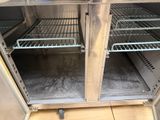 a metal cabinet that has some shelves inside of it