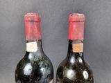 two bottles of wine sitting next to each other on top of a table
