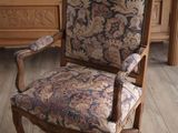 a wooden chair with a floral upholstered seat