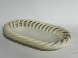 a white plate with a twisted design on it