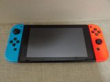 a nintendo switch lite sitting on top of a couch