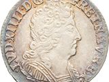 gros plan d'une pièce de monnaie sur laquelle figure une tête de femme