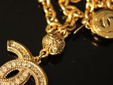 gold plated necklace with a starfish charm on a black surface