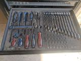 many tools in a tool box on the floor