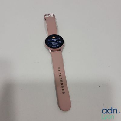 an image of a smart watch sitting on top of a white table